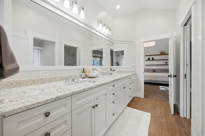 Dual vanity with white cabinetry and dark hardware