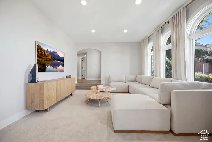 Recessed lighting, arched windows, and an arched doorway