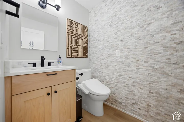 Light wood-finish vanity with a white countertop and matte black fixtures