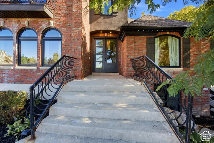 Brick exterior with arched windows and decorative wrought iron railings