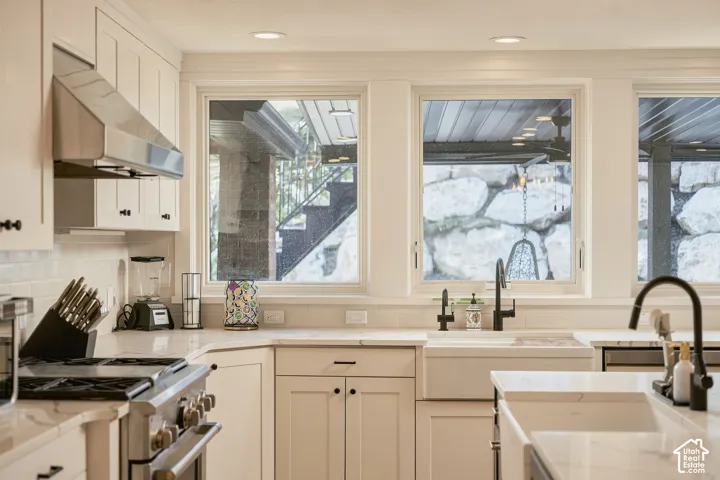 White shaker cabinetry complemented by a subway tile backsplash and recessed lighting
