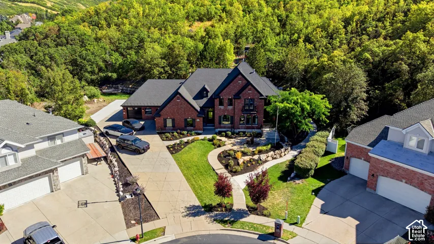 Brick exterior with dark trim accents, multiple gables, and an attached two-car garage