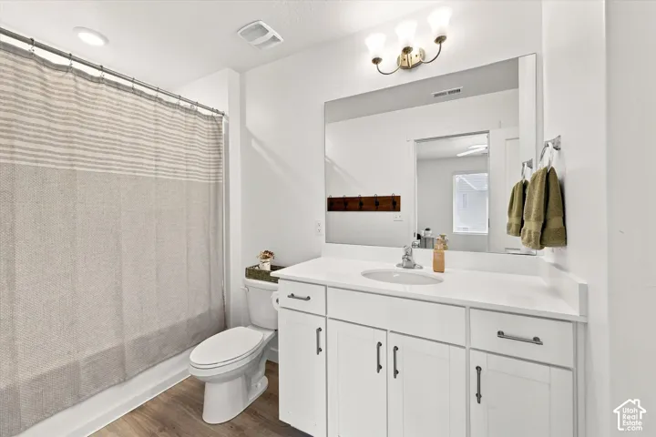 White vanity with an integrated sink, brushed nickel faucet, and a large mirror