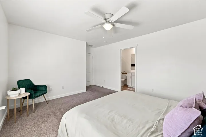 Ceiling fan with integrated lighting, carpeted flooring, and a white interior door