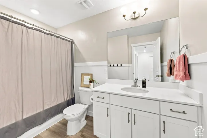 White vanity with dual cabinet storage and drawers, featuring a white countertop with an integrated sink and chrome faucet