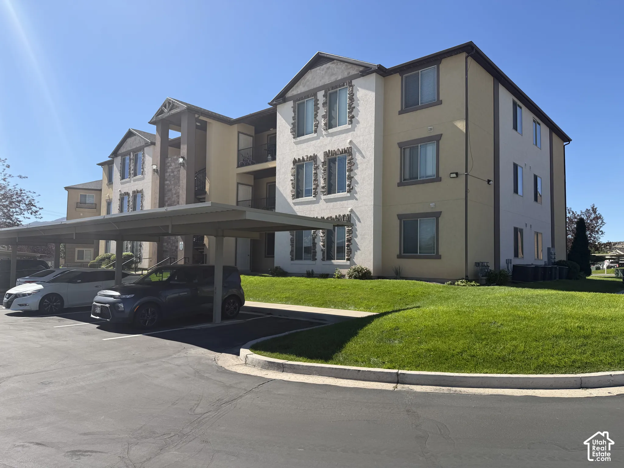 Multi-story building featuring stucco and stone veneer exterior