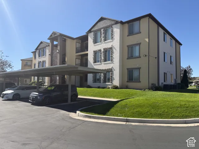 Multi-story building featuring stucco and stone veneer exterior