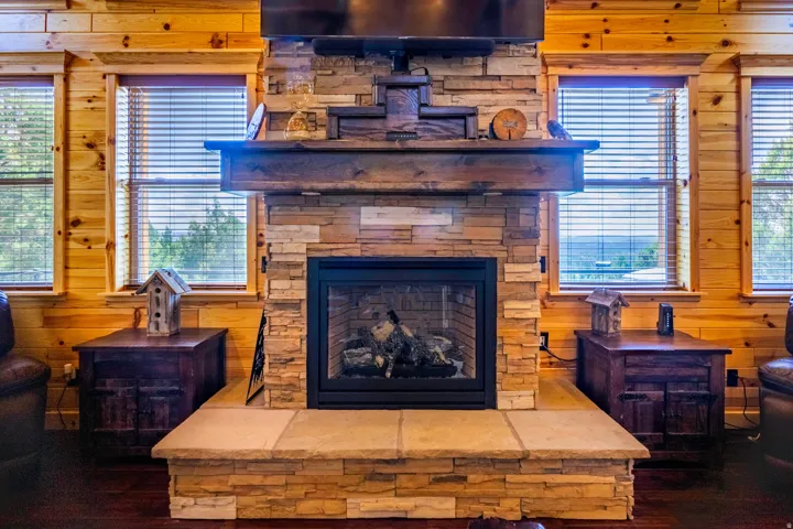 Stone-clad fireplace with a wood mantel
