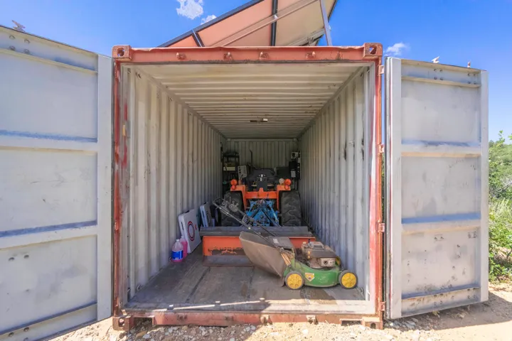 Corrugated steel storage container with large double doors and a wood-finish floor