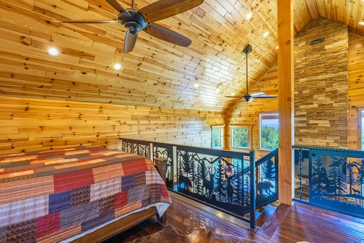 Wood-paneled walls and vaulted ceilings with recessed lighting