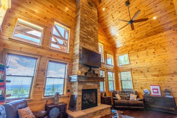 Vaulted wood-paneled ceilings with recessed lighting and ceiling fan