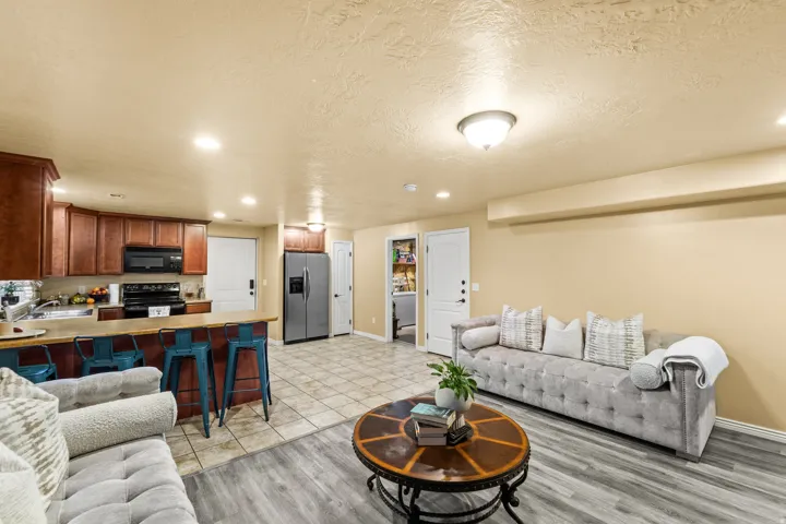 Kitchen with dark wood cabinetry, black appliances, and a breakfast bar. Separate Entrance to Basement