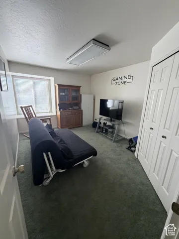 Recessed window with blinds, wall-to-wall carpeting, and bi-fold closet doors