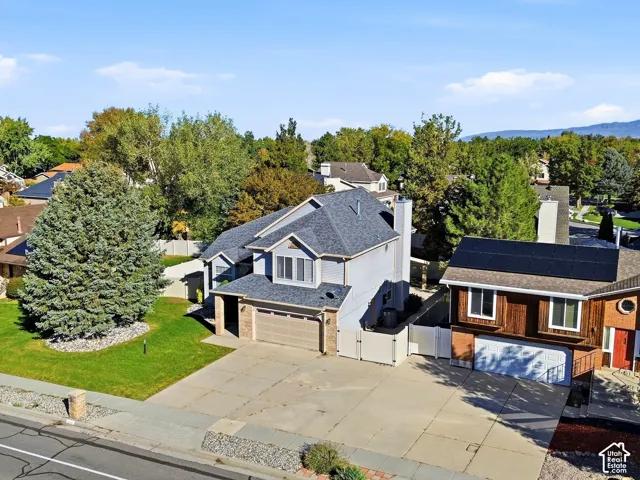 Two-story residence featuring a gray shingle roof, attached two-car garage, and a concrete driveway