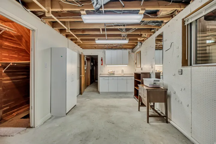 Exposed ceiling joists with overhead strip lighting