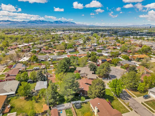 Expansive residential area with mature trees, established homes, and distant mountain scenery