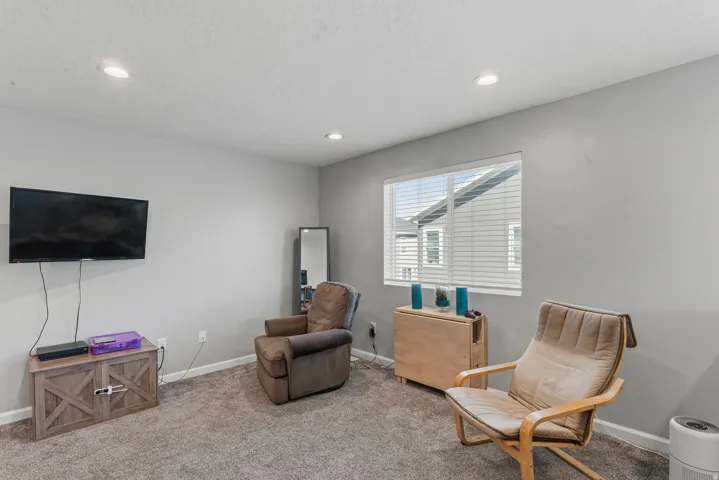 Recessed lighting, light gray wall finishes, window with horizontal blinds, and wall-to-wall carpeting