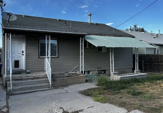 Rear exterior with horizontal siding, covered patio, and metal railings