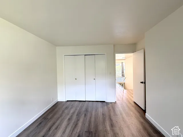 Wood-finish flooring with crisp white baseboards and neutral wall tones