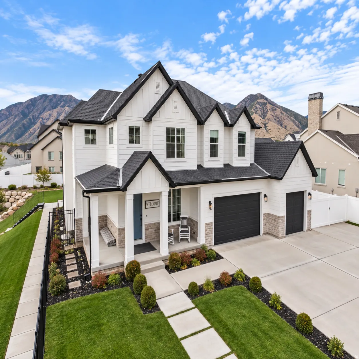 Modern farmhouse exterior featuring white board and batten siding with upgraded black trim accents, RV parking and a huge yard for enjoyment!