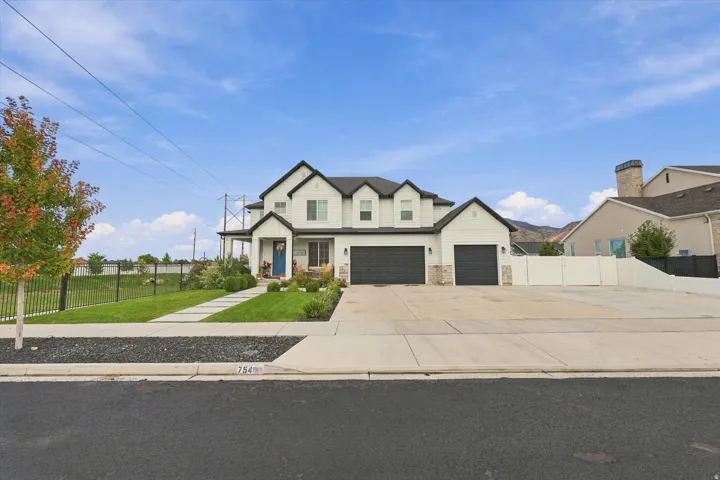 Contemporary two-story exterior with white siding and black trim.