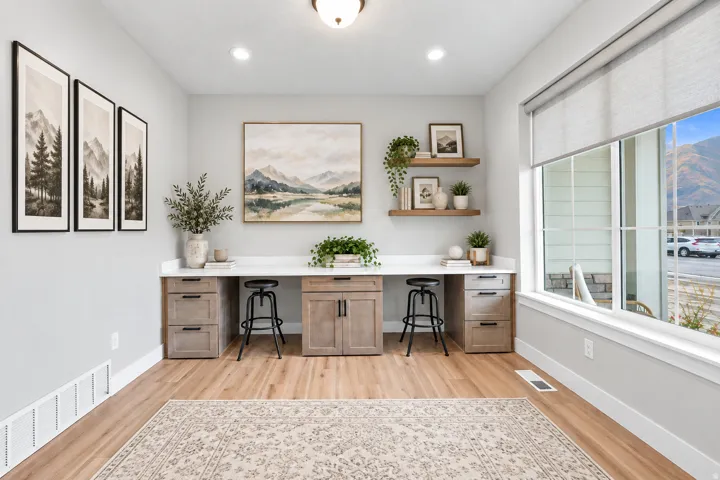 Built-in desk area with wood-finish cabinetry, white countertops, and open shelving