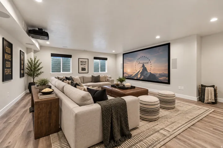 Virtually Staged for Decor Ideas. Recessed lighting throughout, wood-finish flooring, built-in projector, large projection screen, and multiple windows