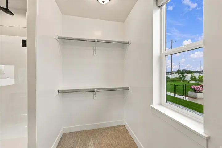 Built-in shelving and hanging rods for organized storage.