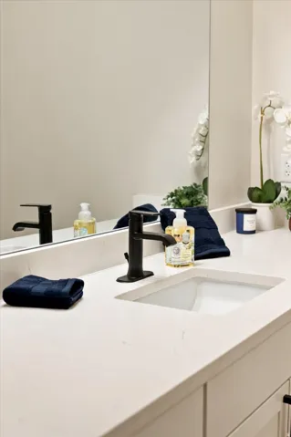 Integrated rectangular sink with a matte black faucet, set within a light-toned countertop.