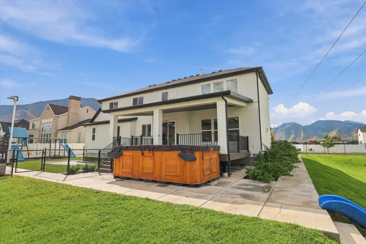 Rear exterior featuring a covered patio and cement pad.