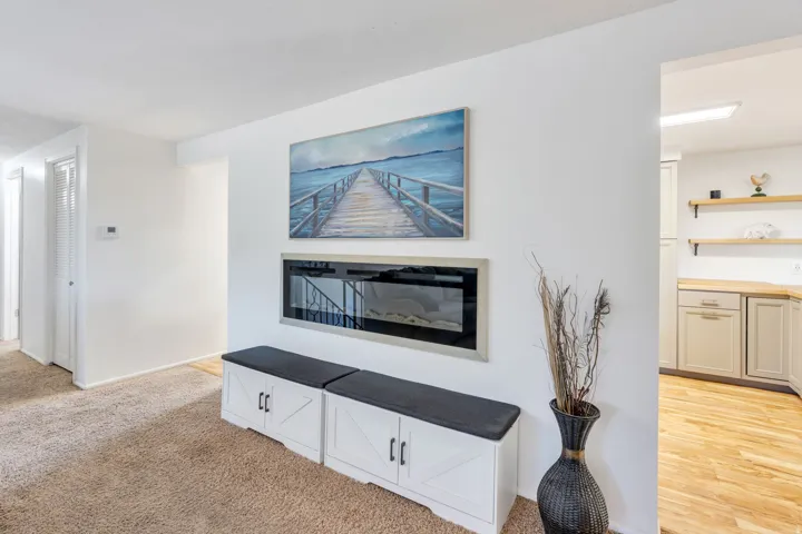 Built-in electric fireplace with brushed metal trim, wall-mounted for a modern aesthetic