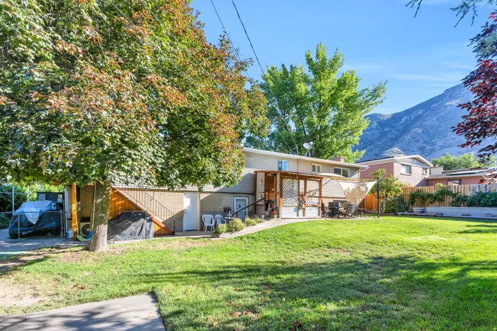 Expansive lawn with mature trees and mountain backdrop