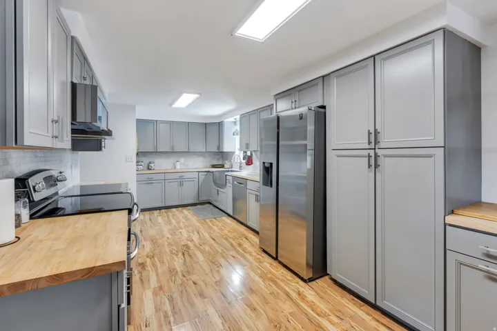 Modern gray cabinets and beautiful wood floors in kitchen