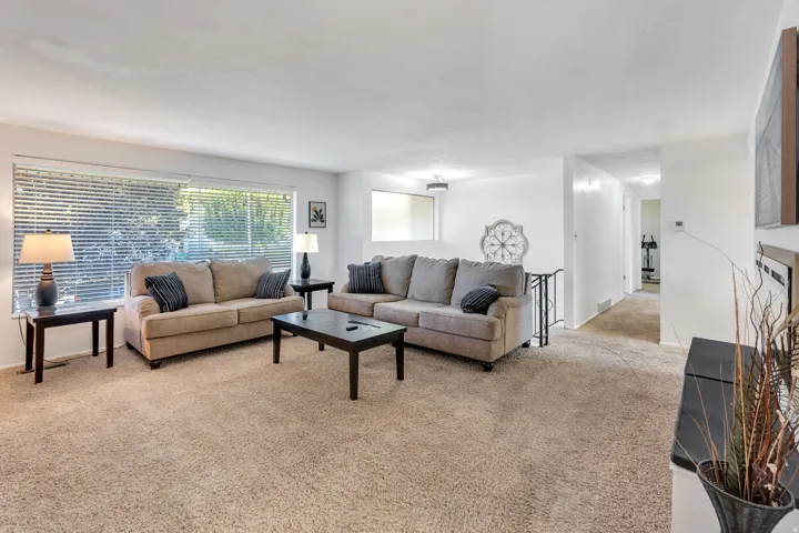 Living room looks out onto mature tree-lined street