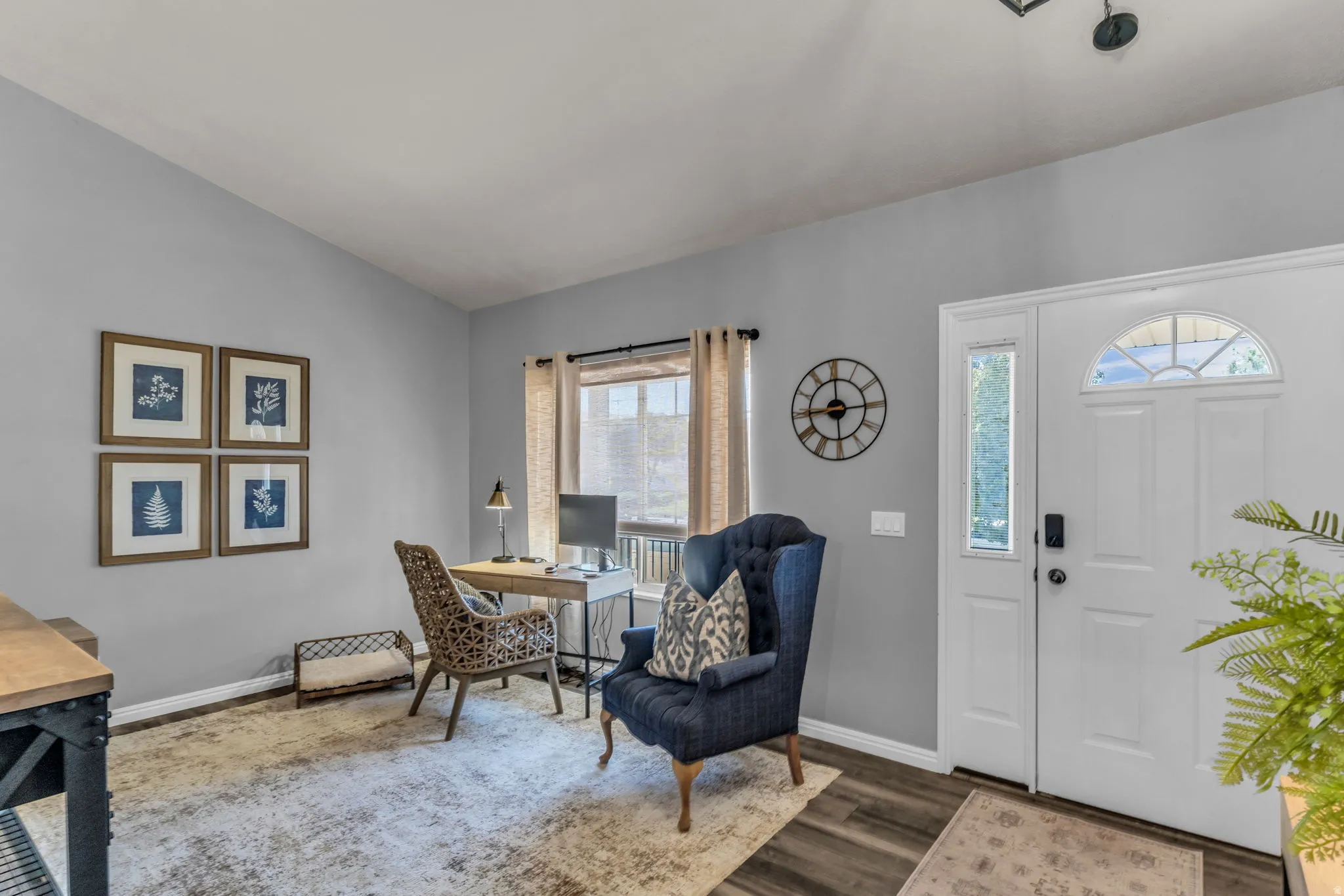 Entryway featuring double doors with transom window, wood-finish flooring, and a window with natural light