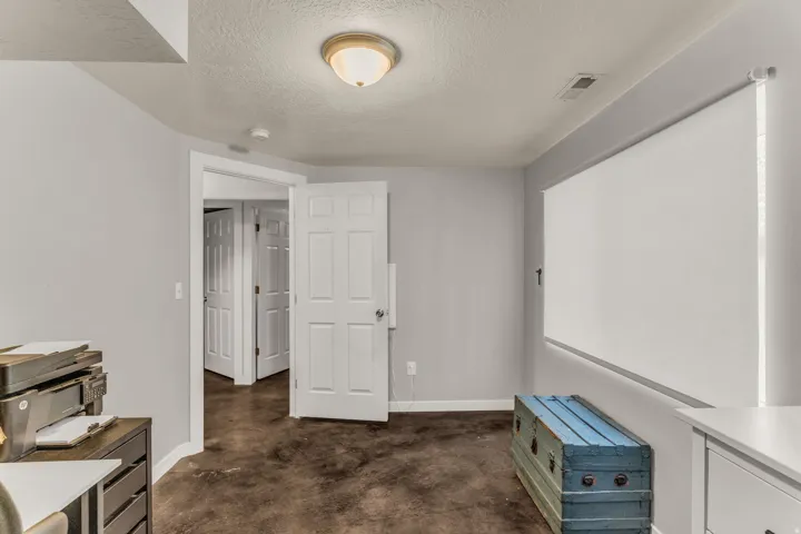 Recessed ceiling lighting, durable flooring, and a window with roller shade