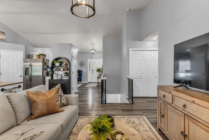 Spacious living area featuring wood-finish flooring, recessed lighting, and a modern ceiling fixture