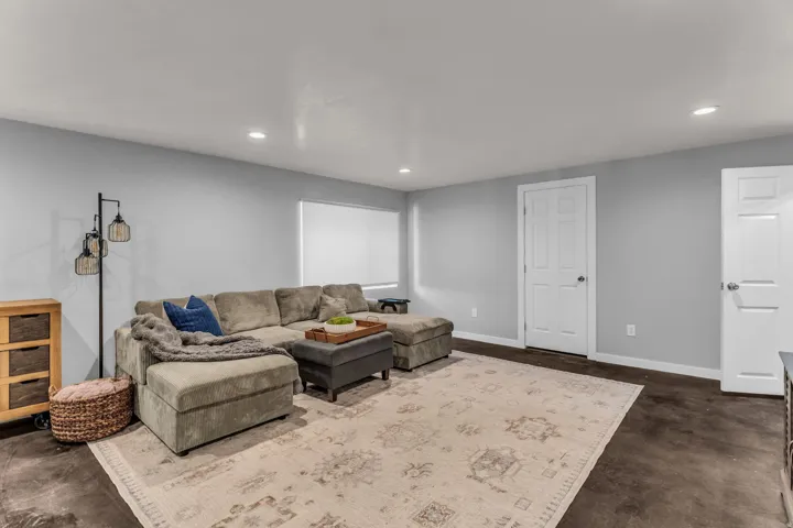 Recessed ceiling lighting illuminates the spacious interior featuring light-toned walls and dark-toned flooring