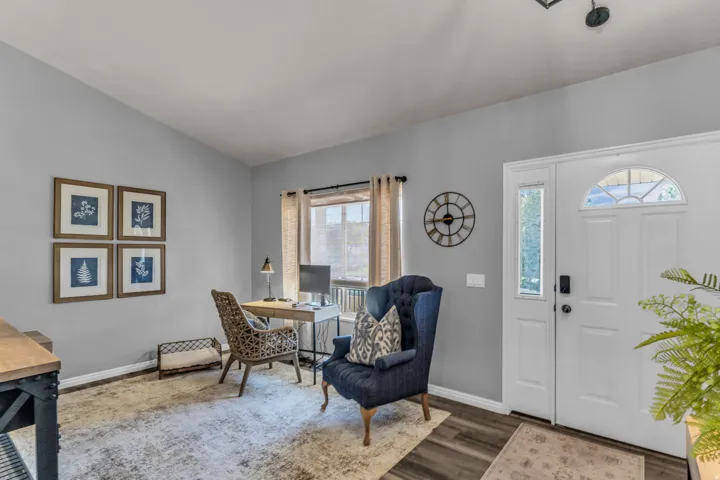 Entryway featuring double doors with transom window, wood-finish flooring, and a window with natural light