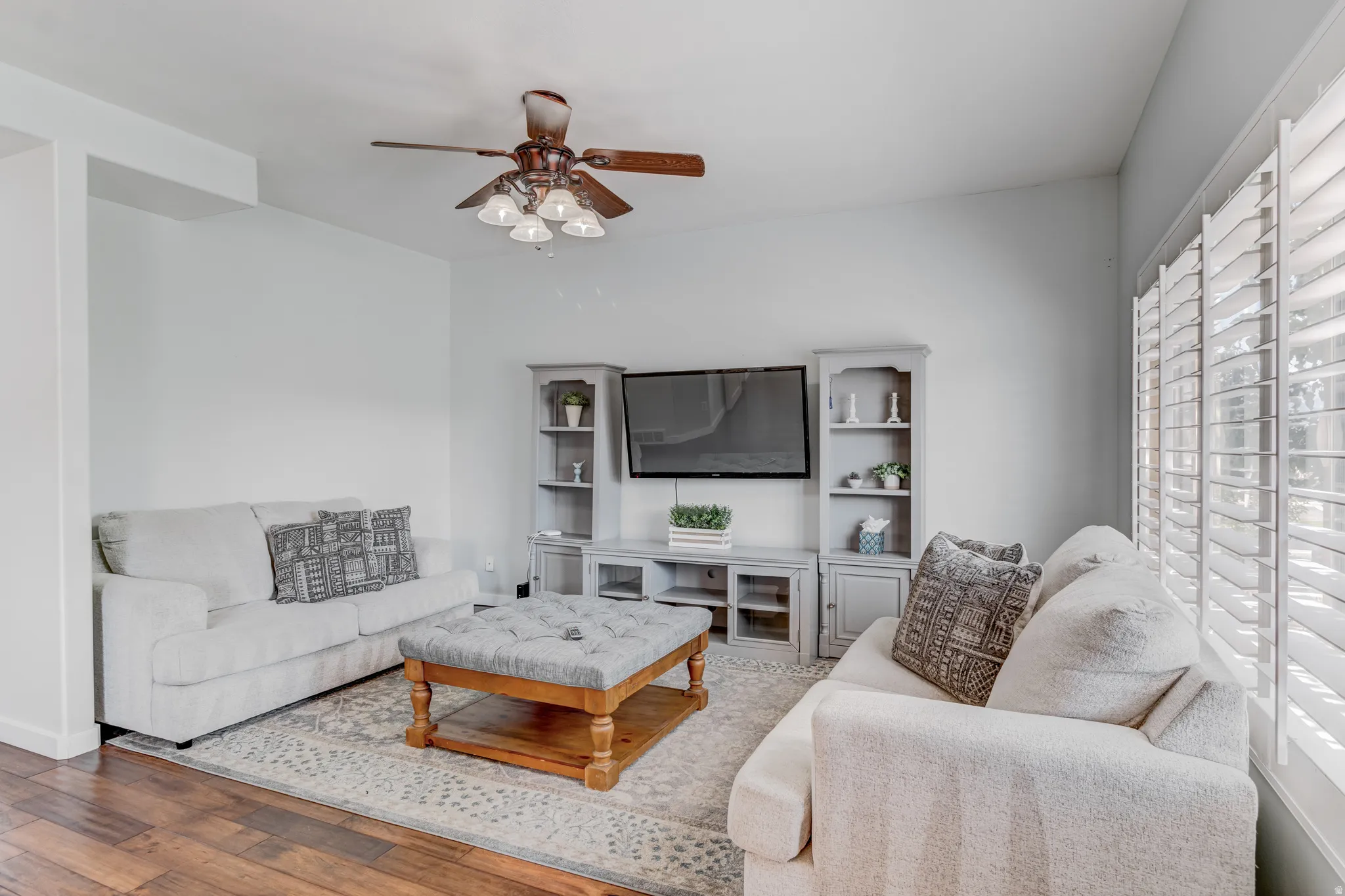 Wood-finish flooring with a ceiling fan light fixture