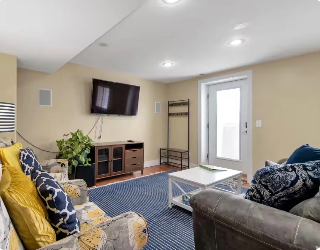 Recessed lighting, wood-finish flooring, white trim, and a white door with frosted glass
