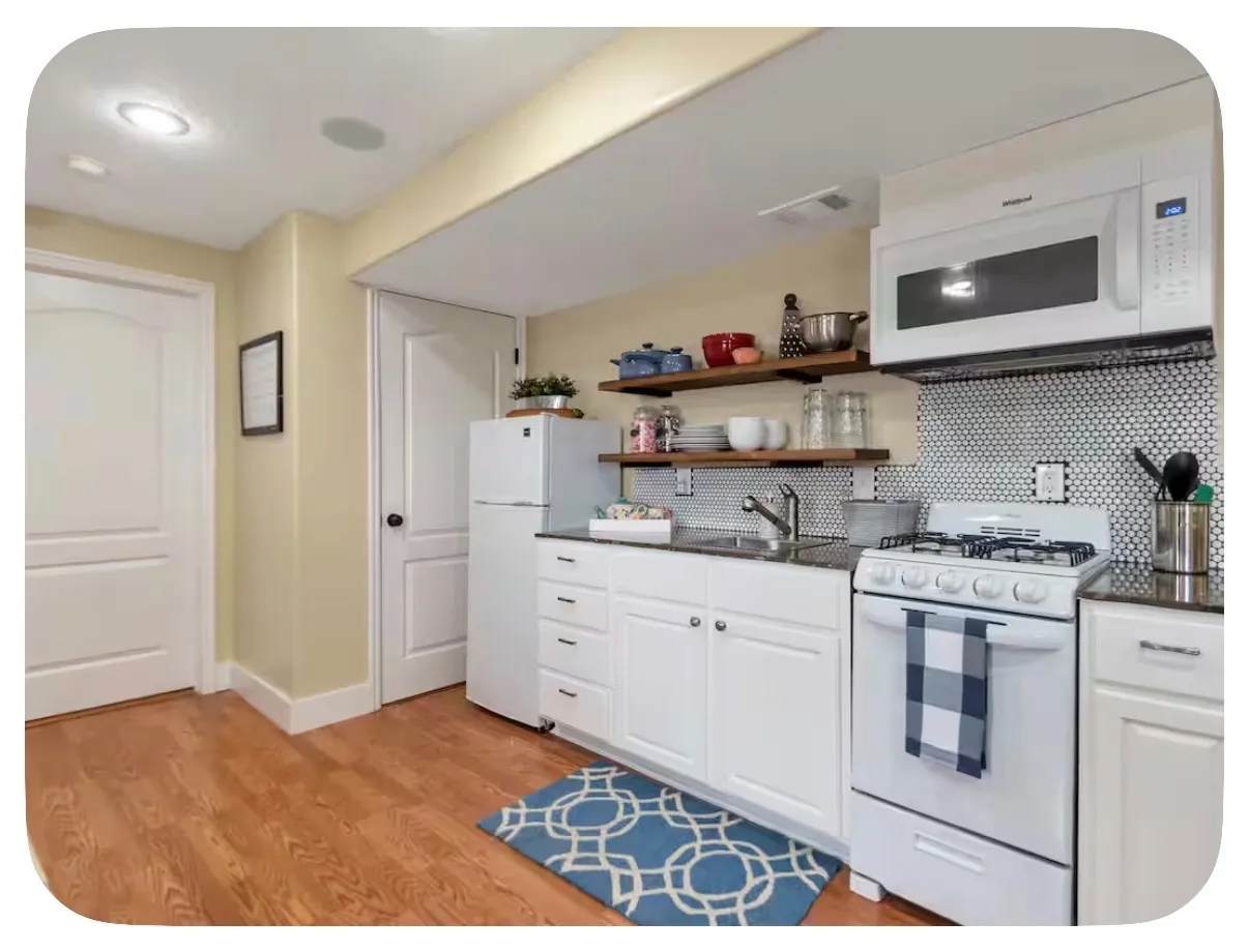 Wood-finish flooring, recessed lighting, white cabinetry, integrated sink, and white appliances