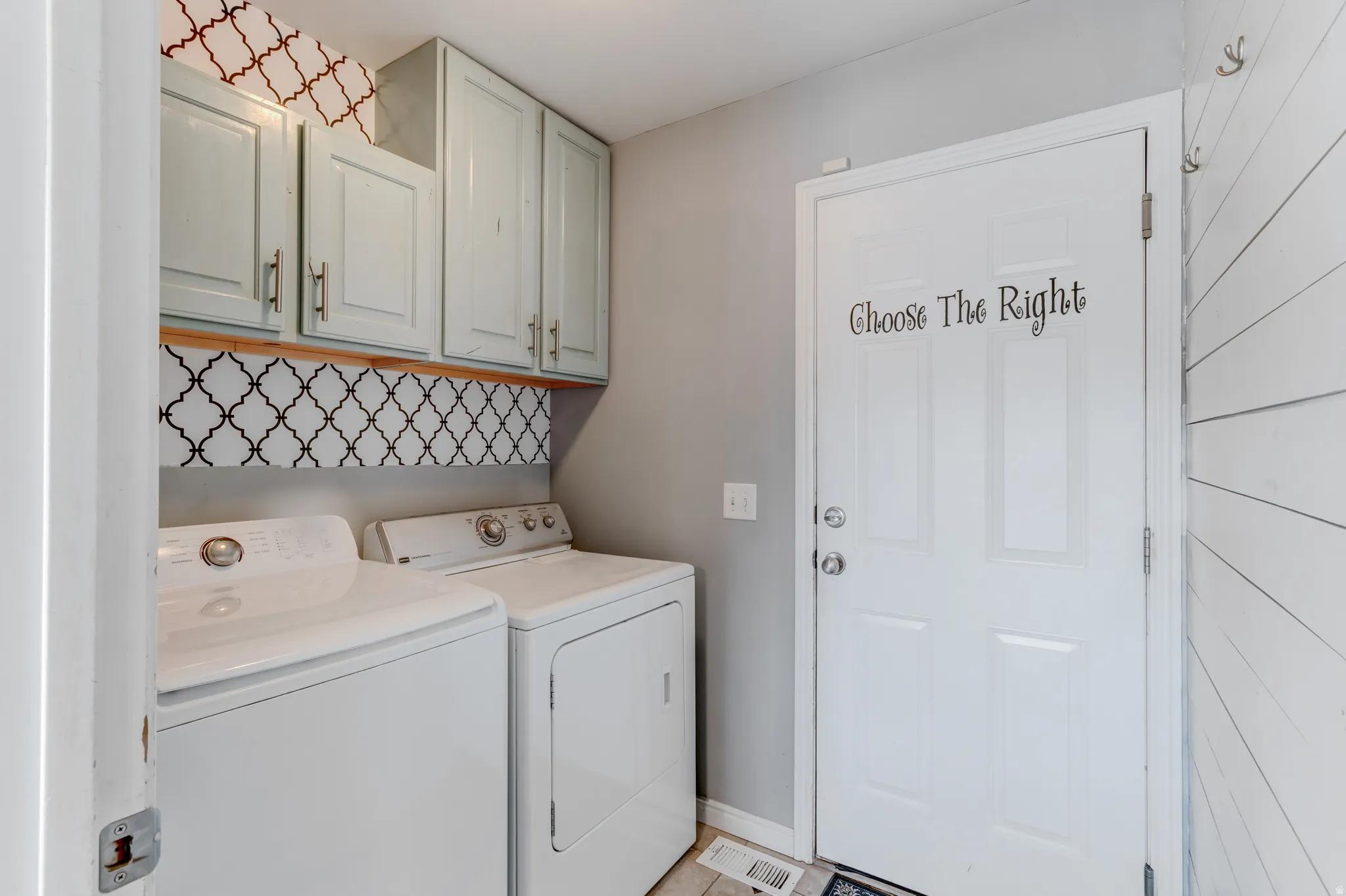 Light blue wall-mounted cabinetry, Moroccan tile-patterned backsplash, and wood-finish shelving