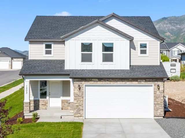 Contemporary exterior with stone accents, a covered front porch, and a two-car garage