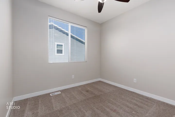 Neutral-toned walls complement the textured carpet flooring