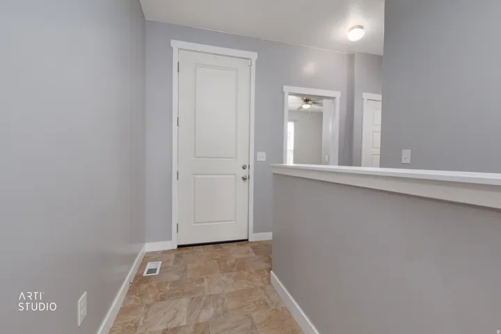 white trim, paneled door, and neutral wall tones