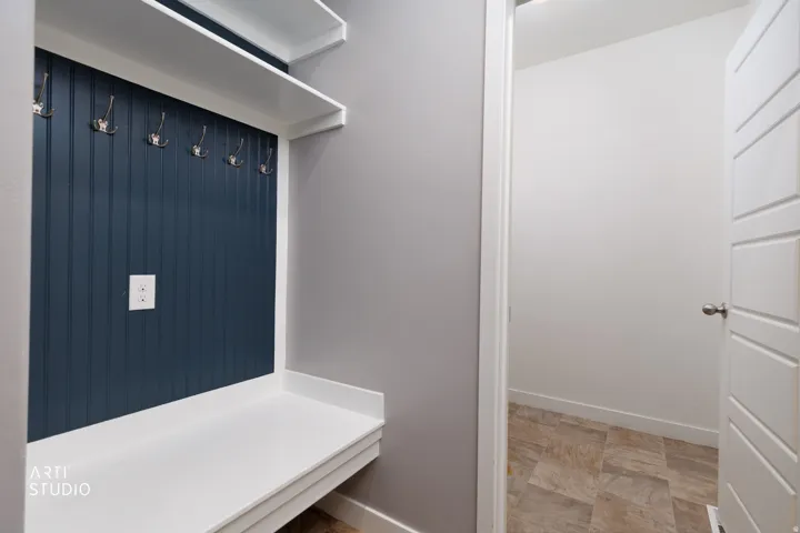 Built-in bench with integrated shelving and storage hooks