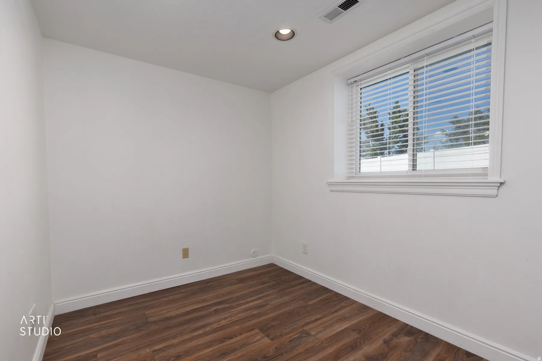 Wood-finish flooring, recessed lighting, and a window with blinds and white trim