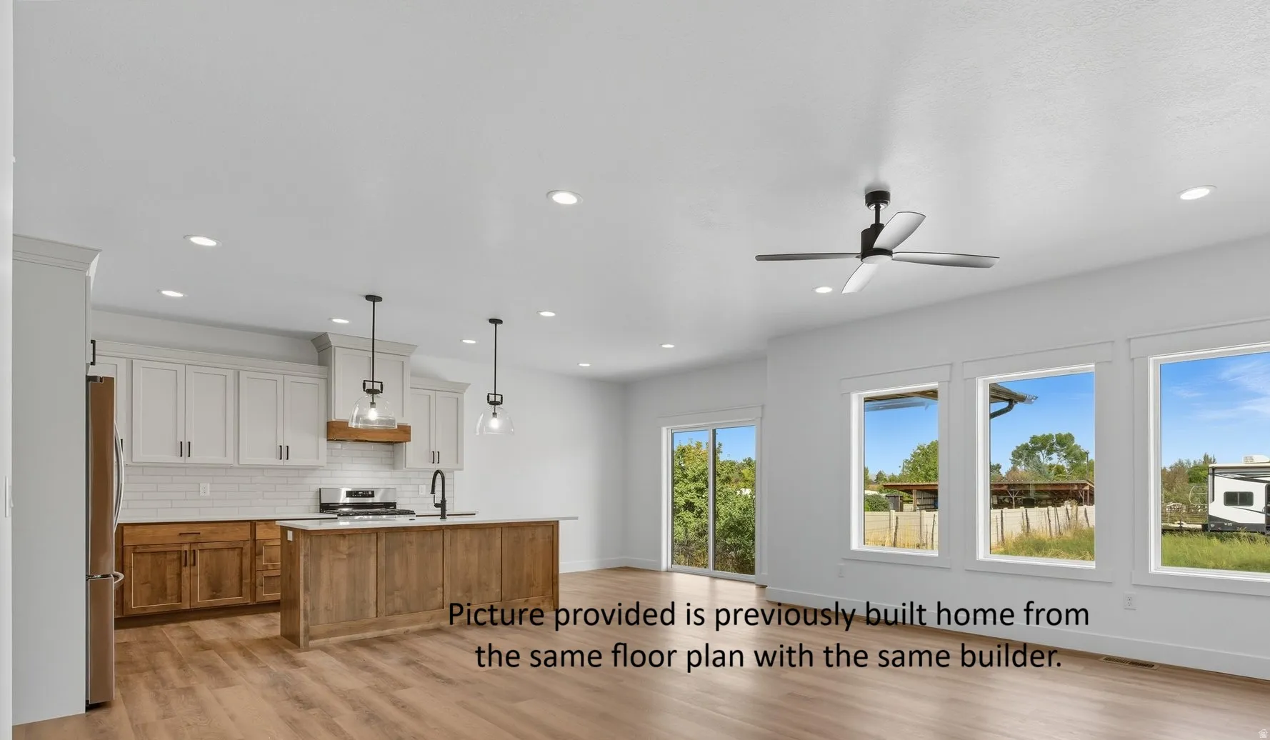 Open-concept living space with wood-finish flooring