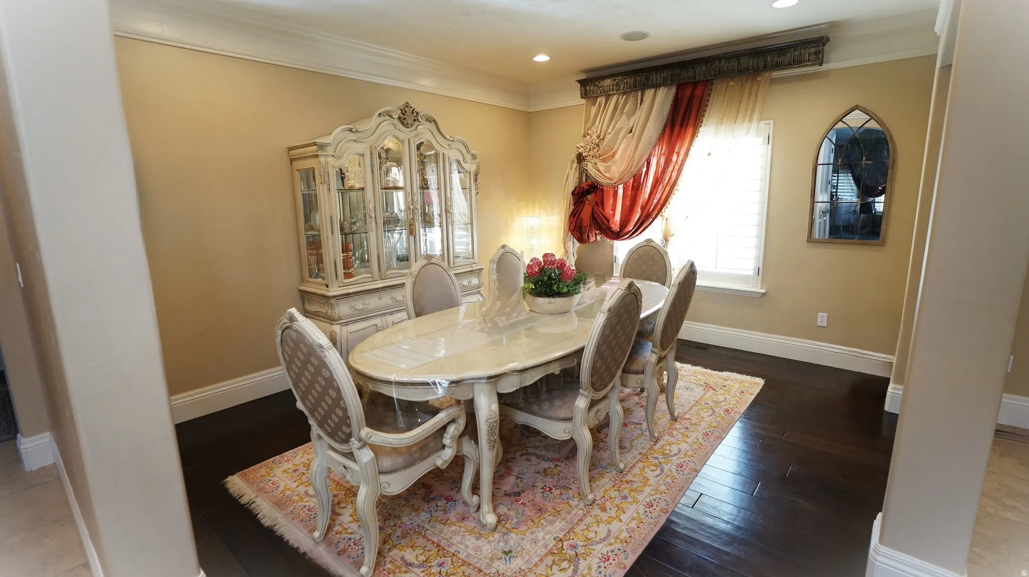 Dark wood-finish flooring with a light wall color and white crown molding